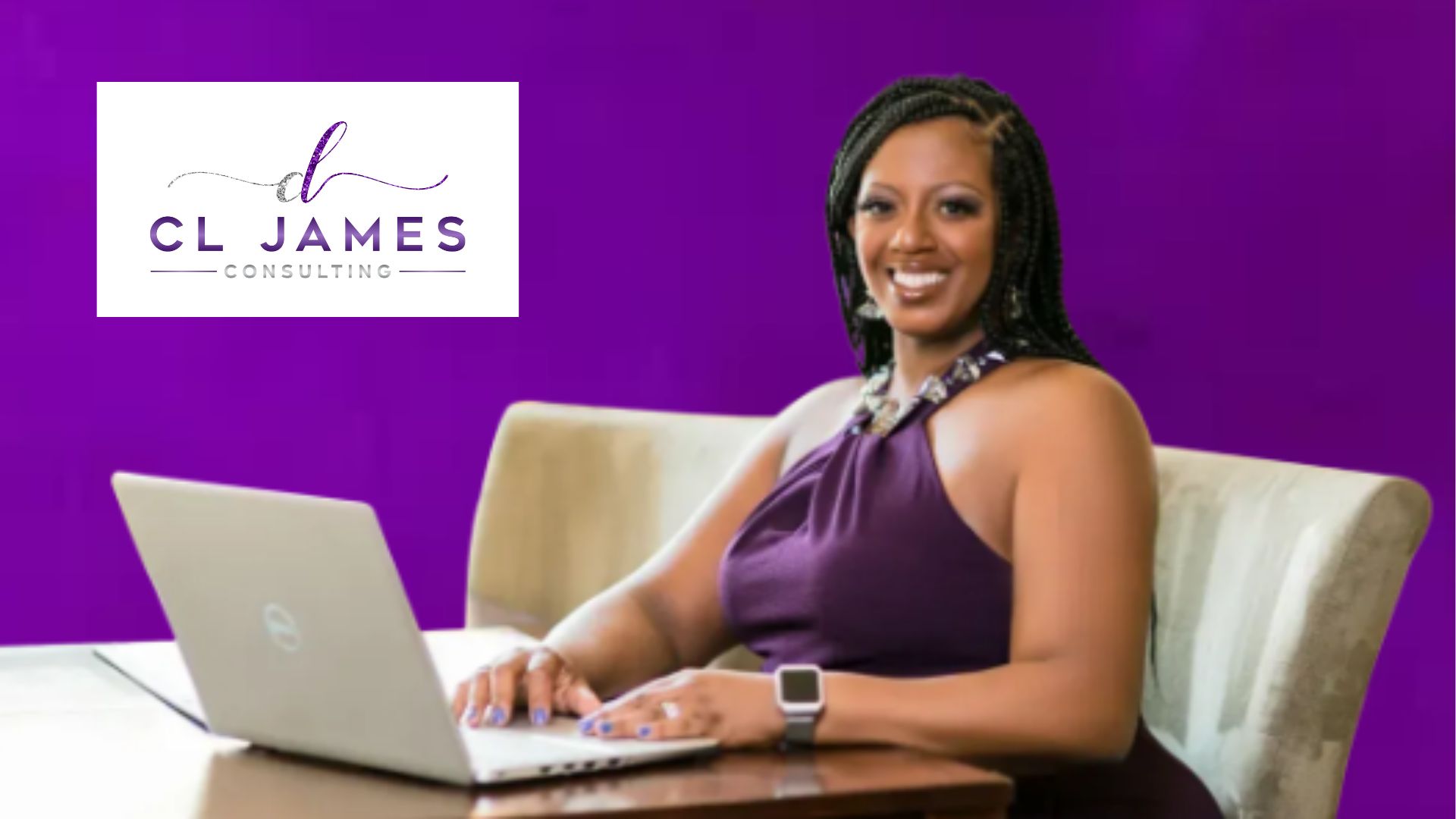 Business consultant Cheryl James sitting at her desk smiling