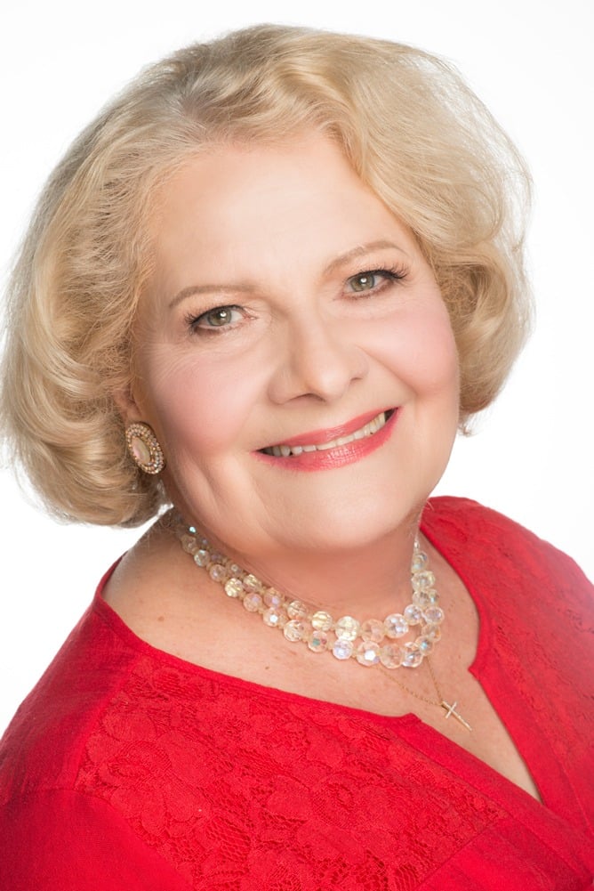 Headshot of Carol Stanley wearing a red top