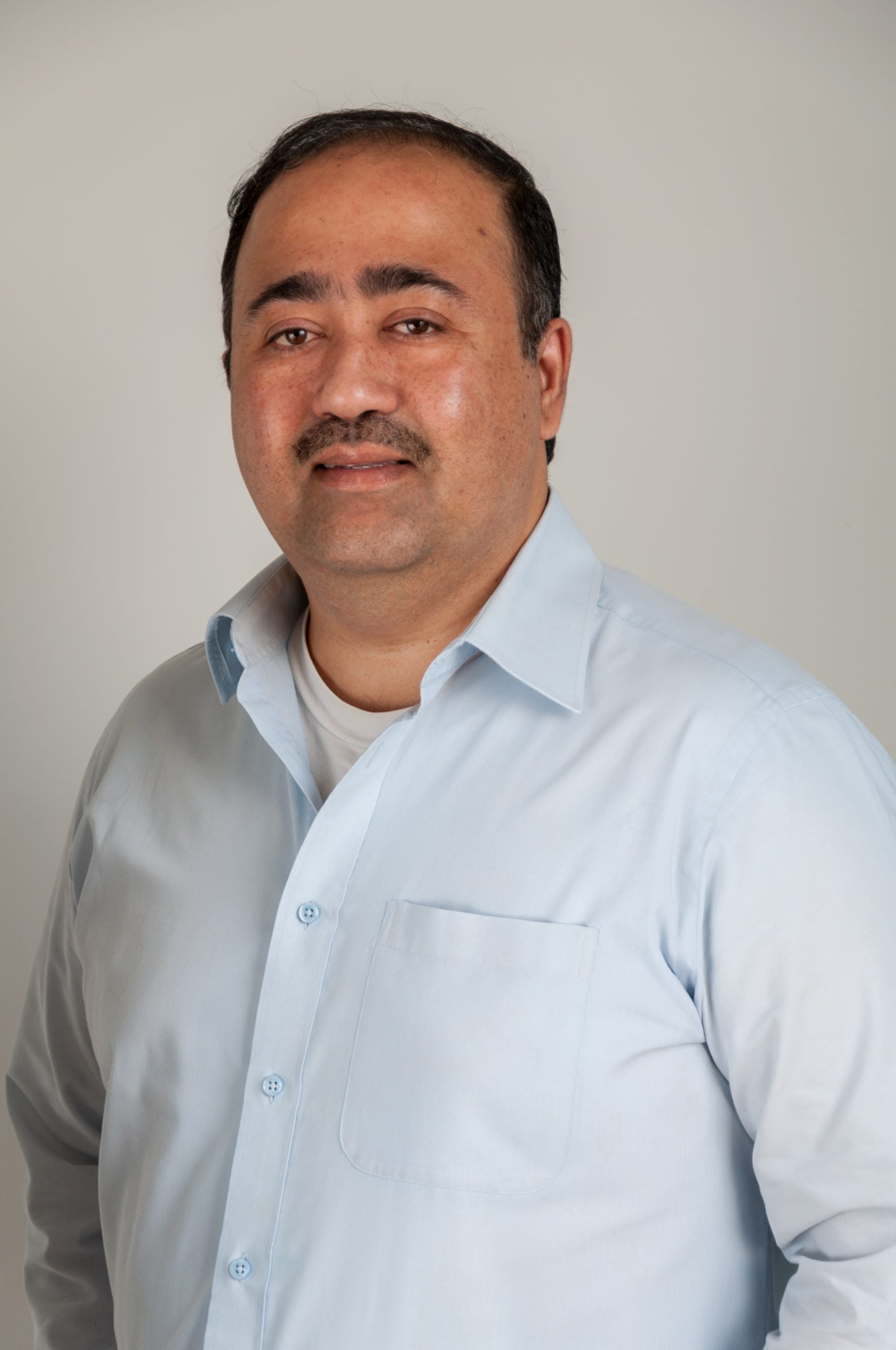 Headshot of Indranil Mukherjee - male with black hair wearing light blue shirt Headshot of Indranil Mukherjee - male with black hair wearing light blue shirt