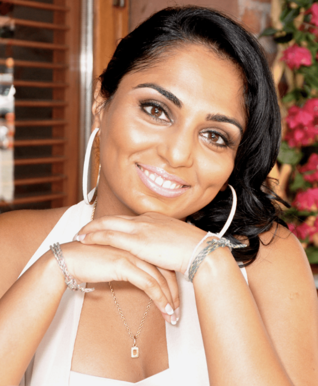 Headshot of Kay Suthar - woman with black hair pulled to side smiling with large earrings Headshot of Kay Suthar - woman with black hair pulled to side smiling with large earrings