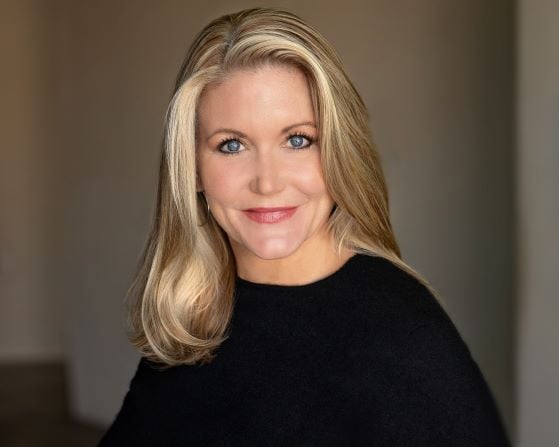 Linda Fisk in black blouse with long blonde hair Headshot of Linda Fisk