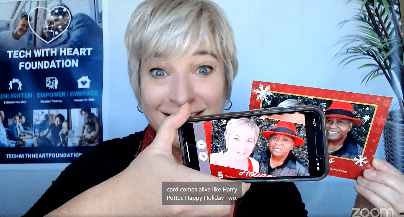 Photo of Michelle Calloway - holding cell phone with image from holiday card Photo of Michelle Calloway - holding cell phone with image from holiday card