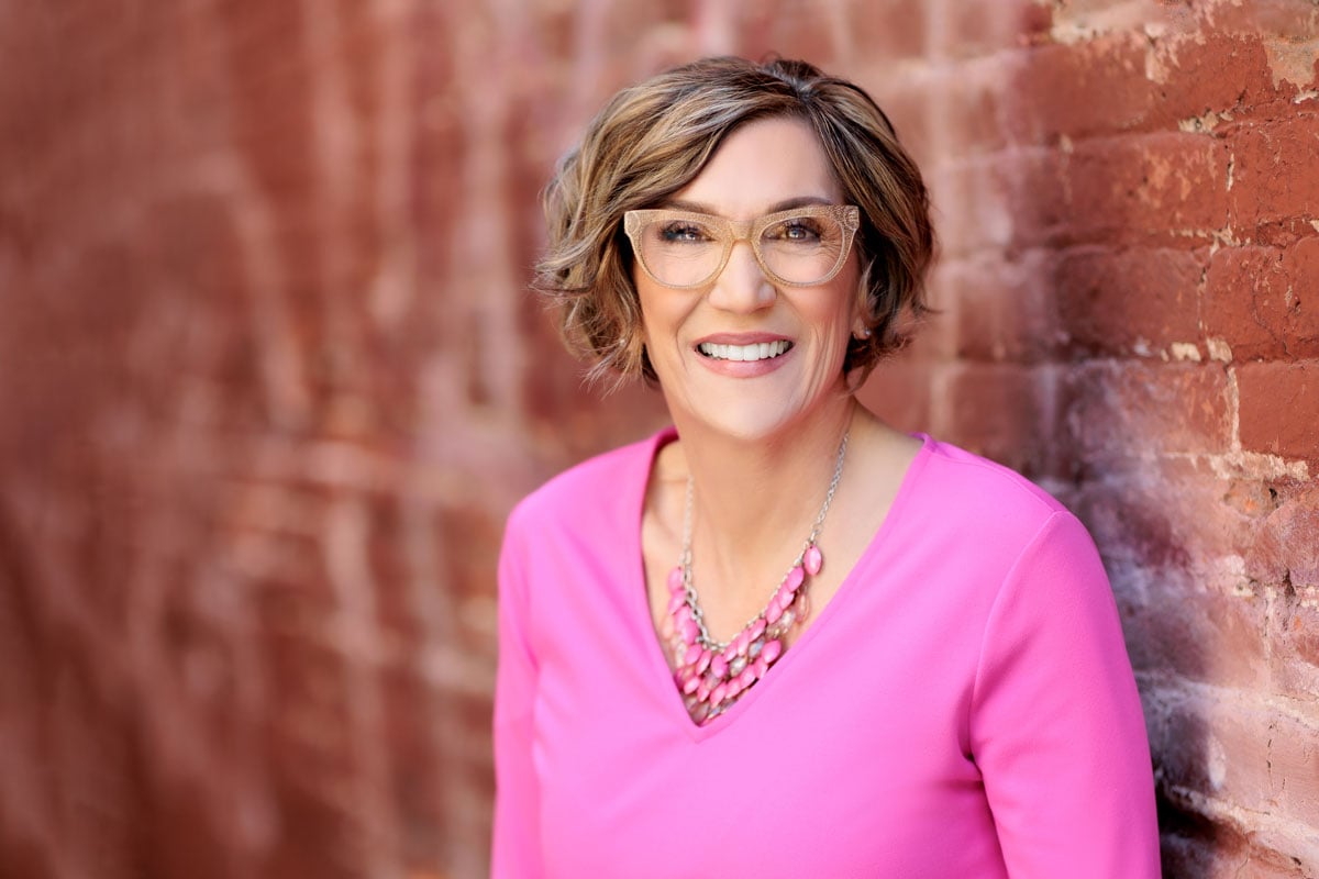 SFrew-pink-top Headshot of AI Keynote Speaker, Susan Frew wearing a pink blouse